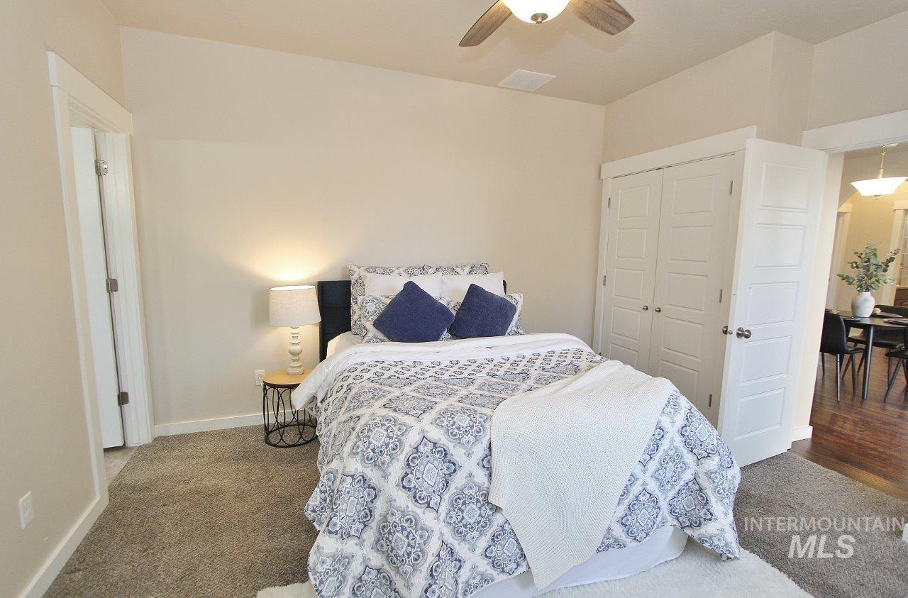 Bedroom featuring ceiling fan, a closet, and carpet