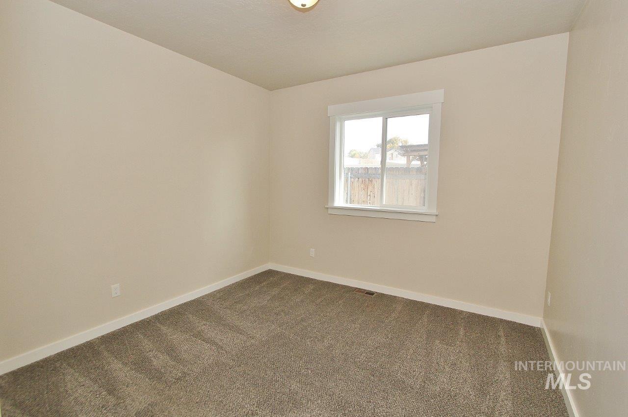 Unfurnished room with carpet and baseboards