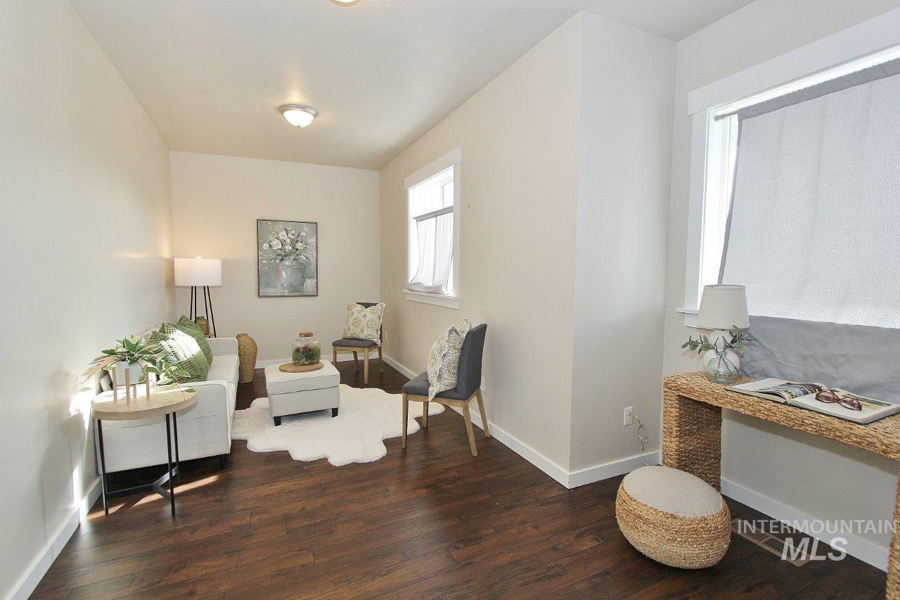Sitting room with baseboards and dark wood finished floors