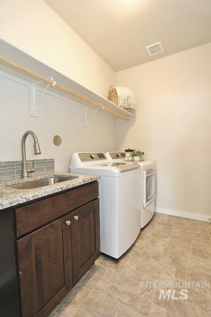 Laundry area featuring washing machine and dryer and cabinet space