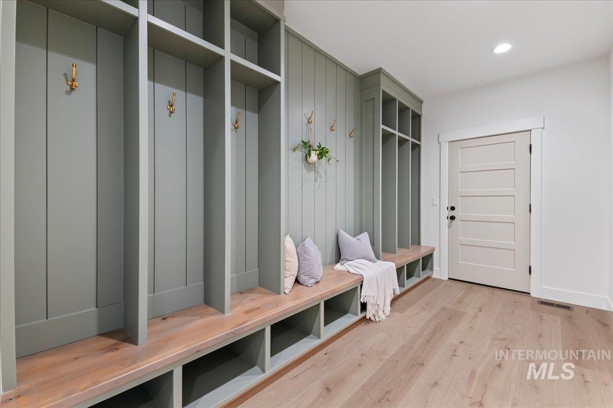 Mudroom featuring light wood finished floors and recessed lighting