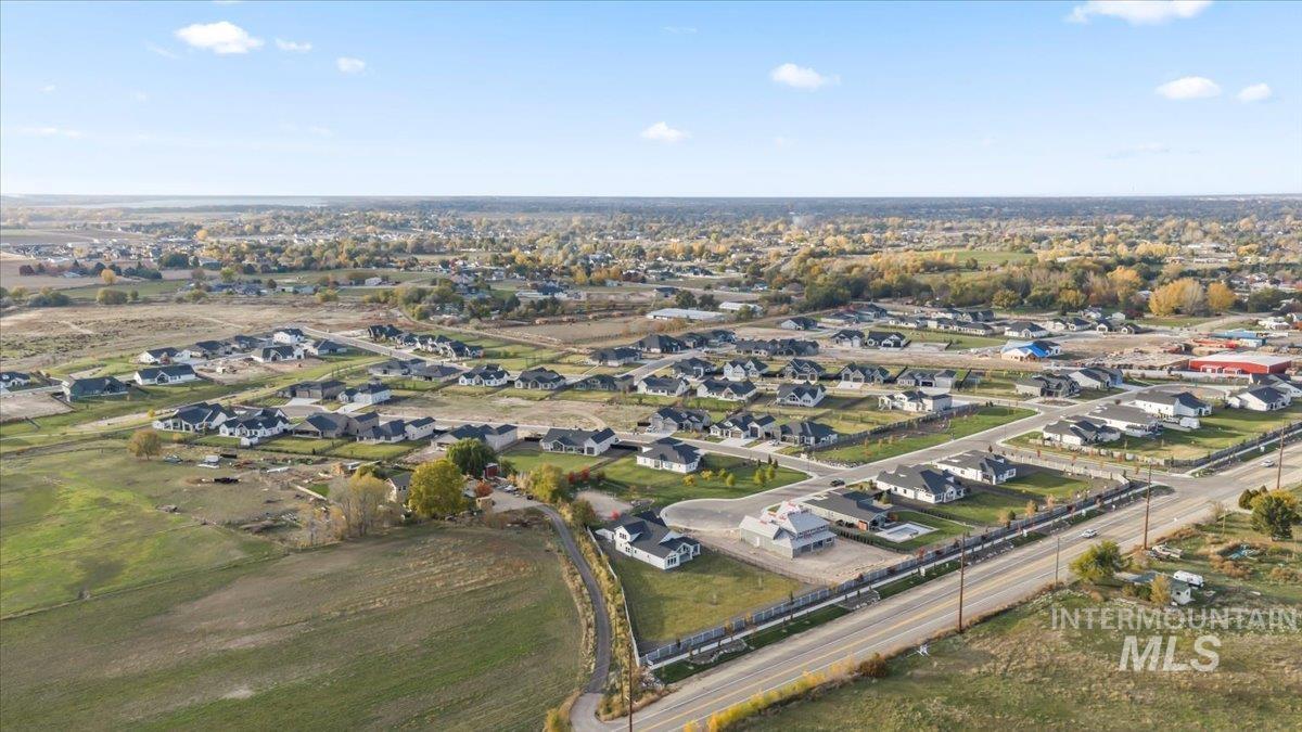 Aerial view of property's location featuring nearby suburban area