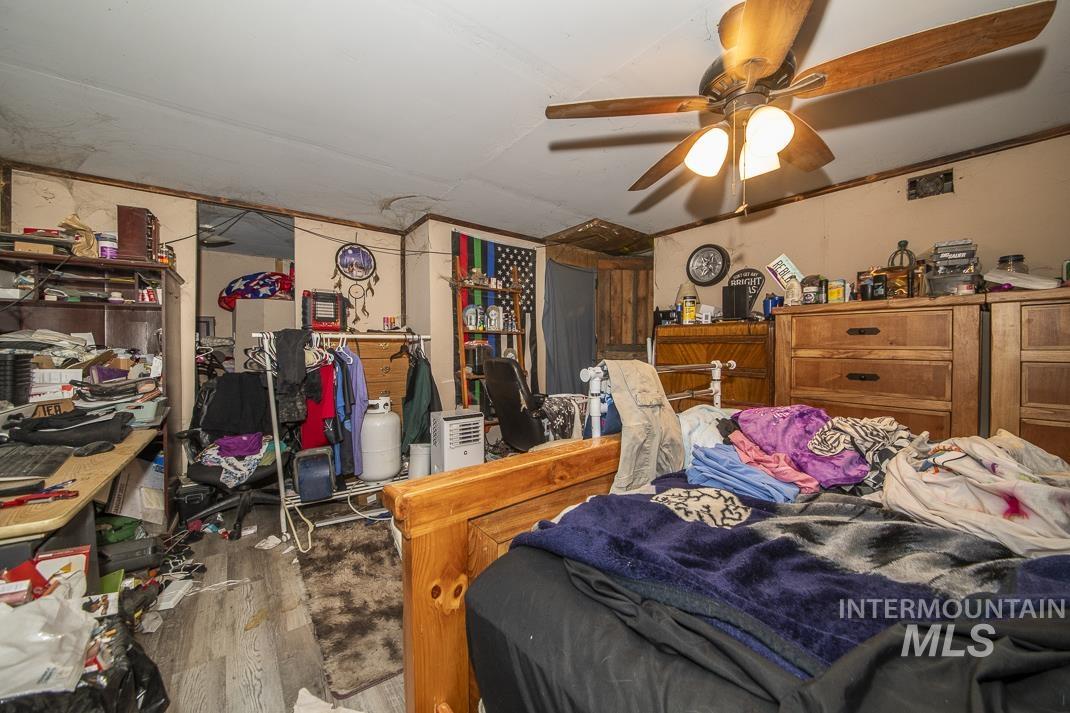 Bedroom with wood finished floors and a ceiling fan