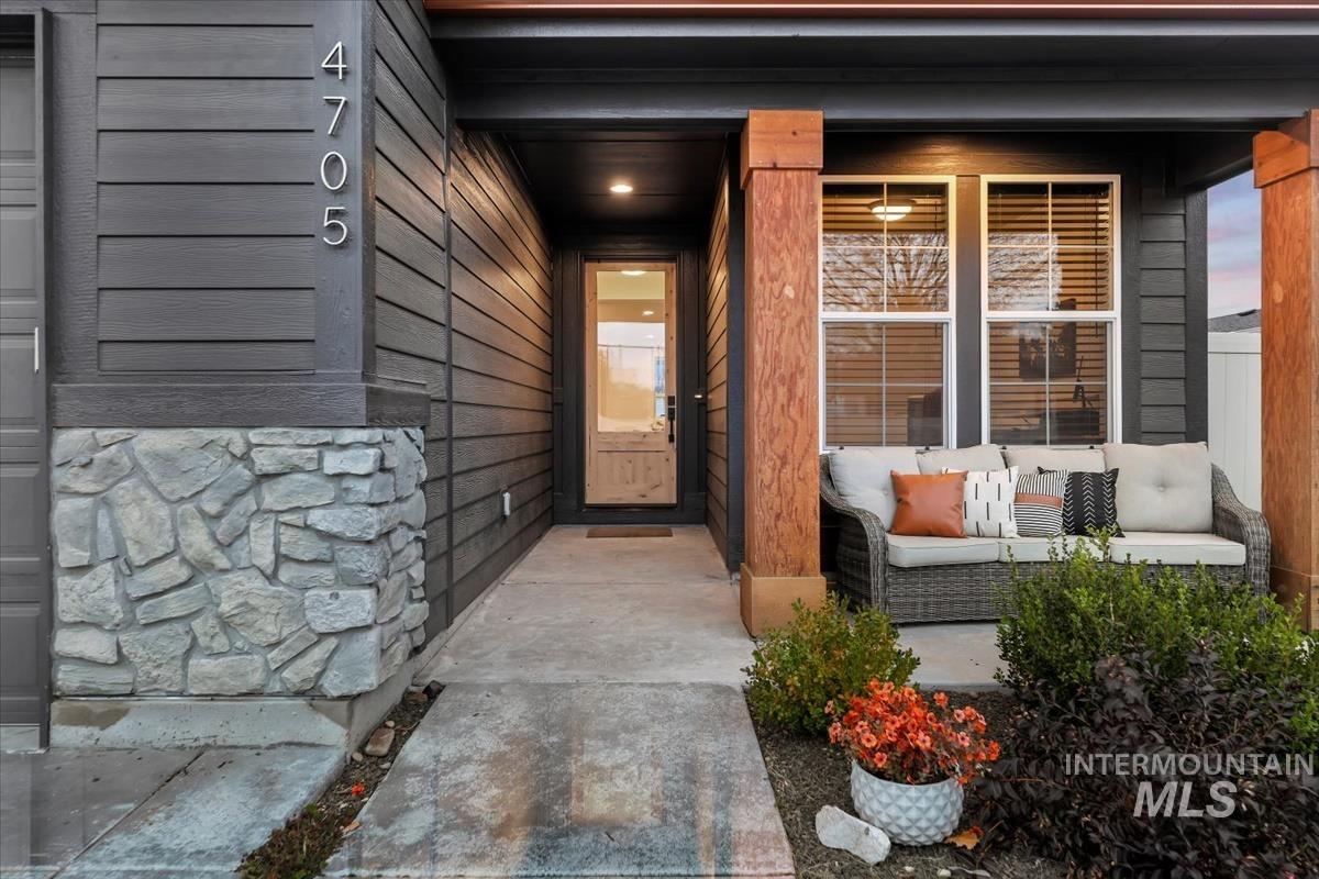 Entrance to property with stone siding and covered porch