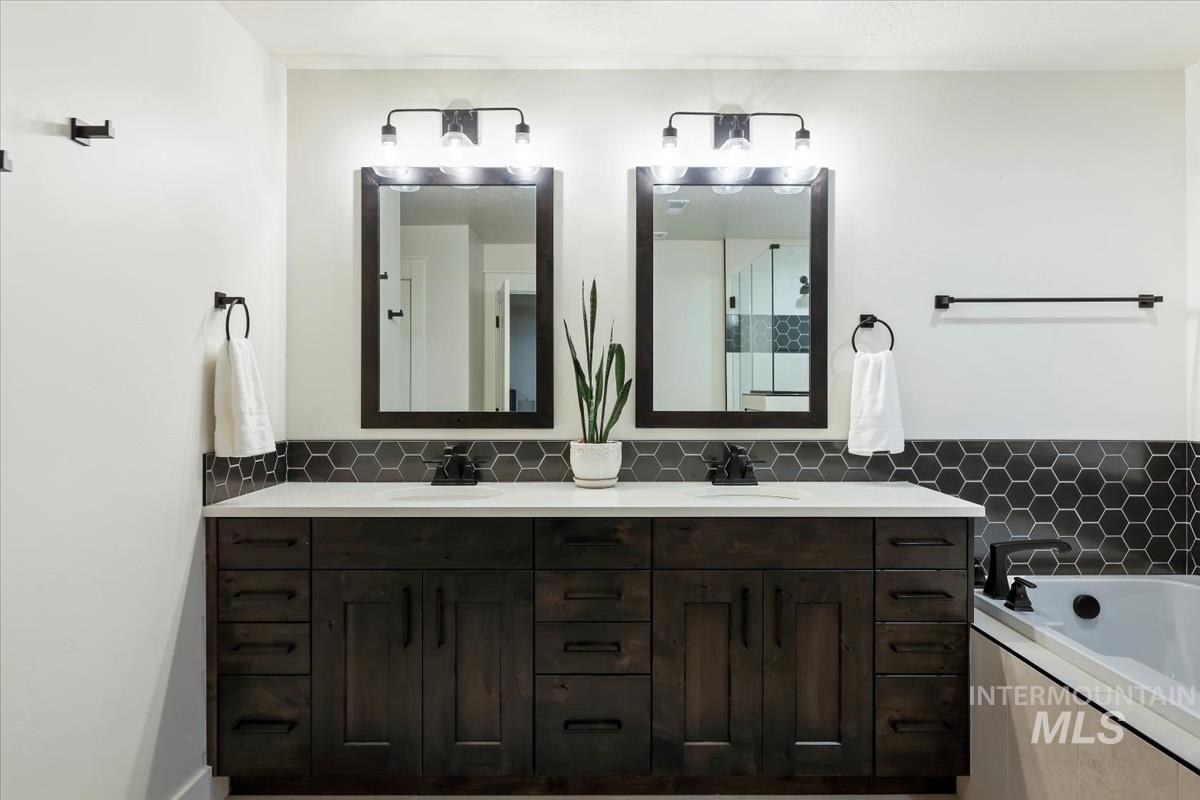 Bathroom featuring double vanity and a garden tub
