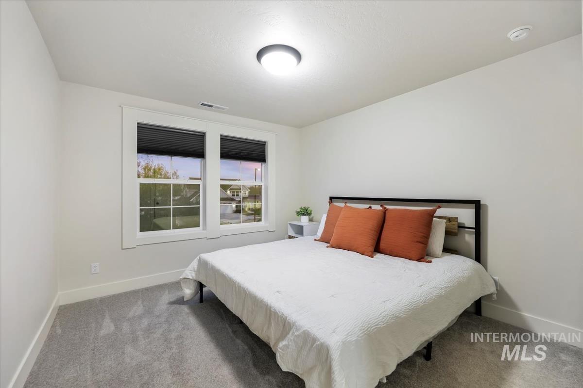 Carpeted bedroom with baseboards