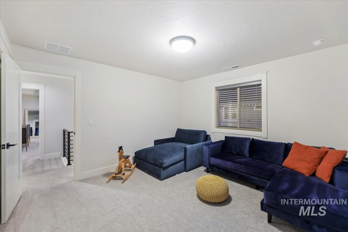 Living area with carpet flooring and baseboards