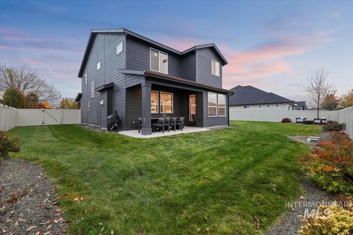 Back of house featuring a patio, a fenced backyard, and a gate