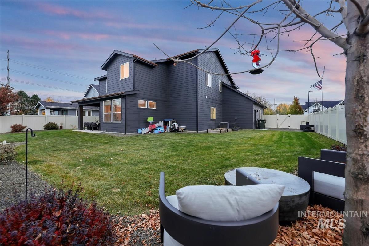 Rear view of property with a patio area and a fenced backyard