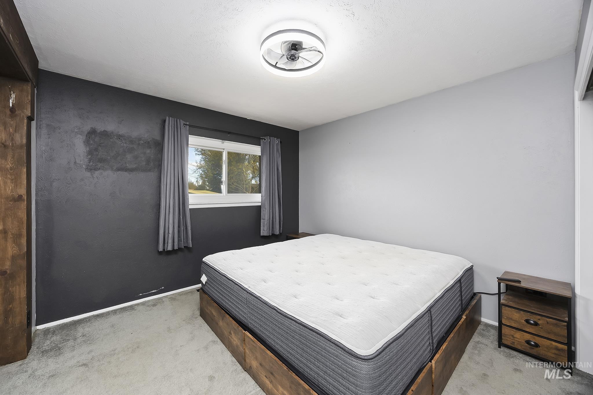 Bedroom featuring light carpet