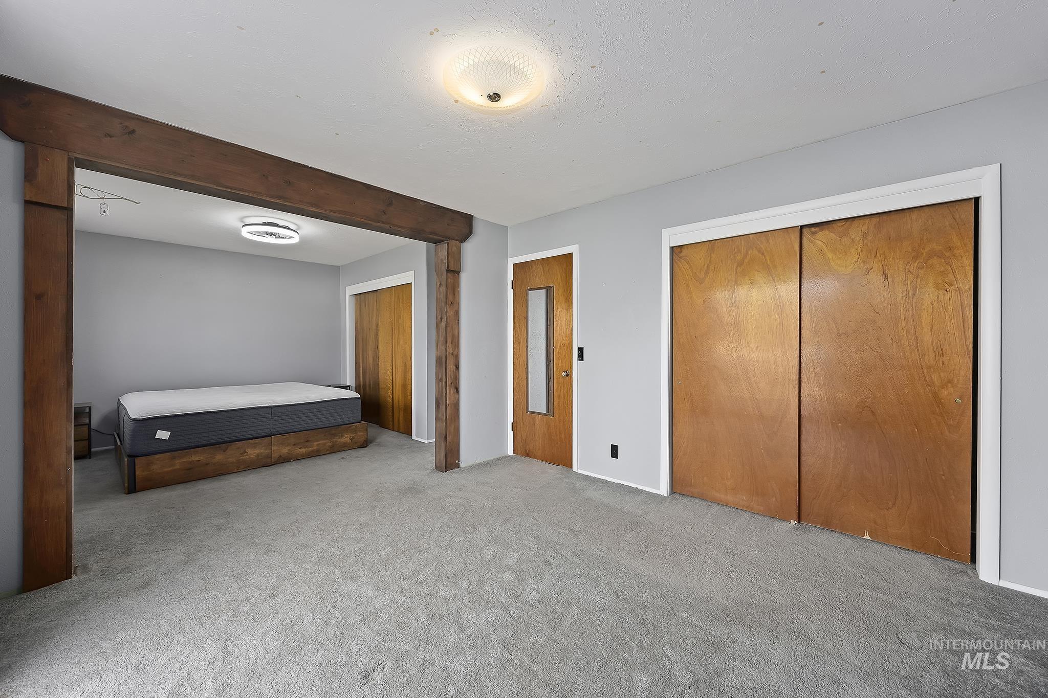 Unfurnished bedroom featuring carpet and a closet