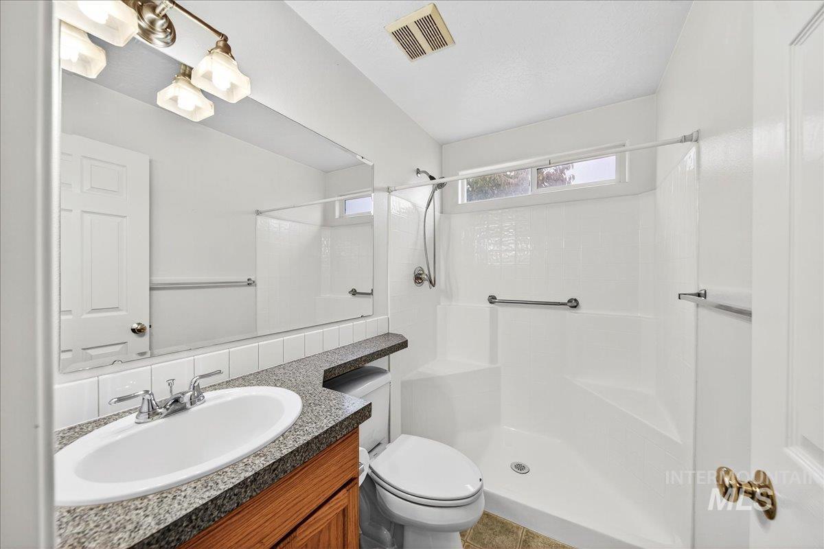 Bathroom with vanity and a shower