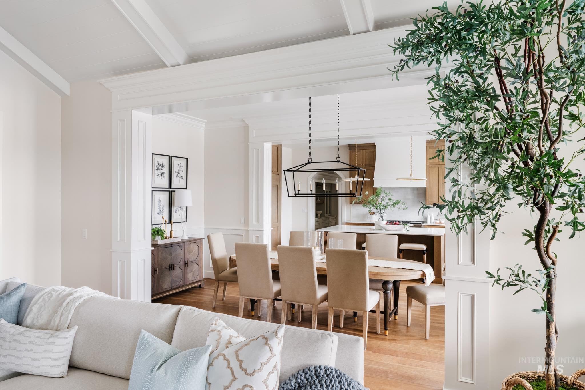 Dining room with light wood finished floors and beam ceiling