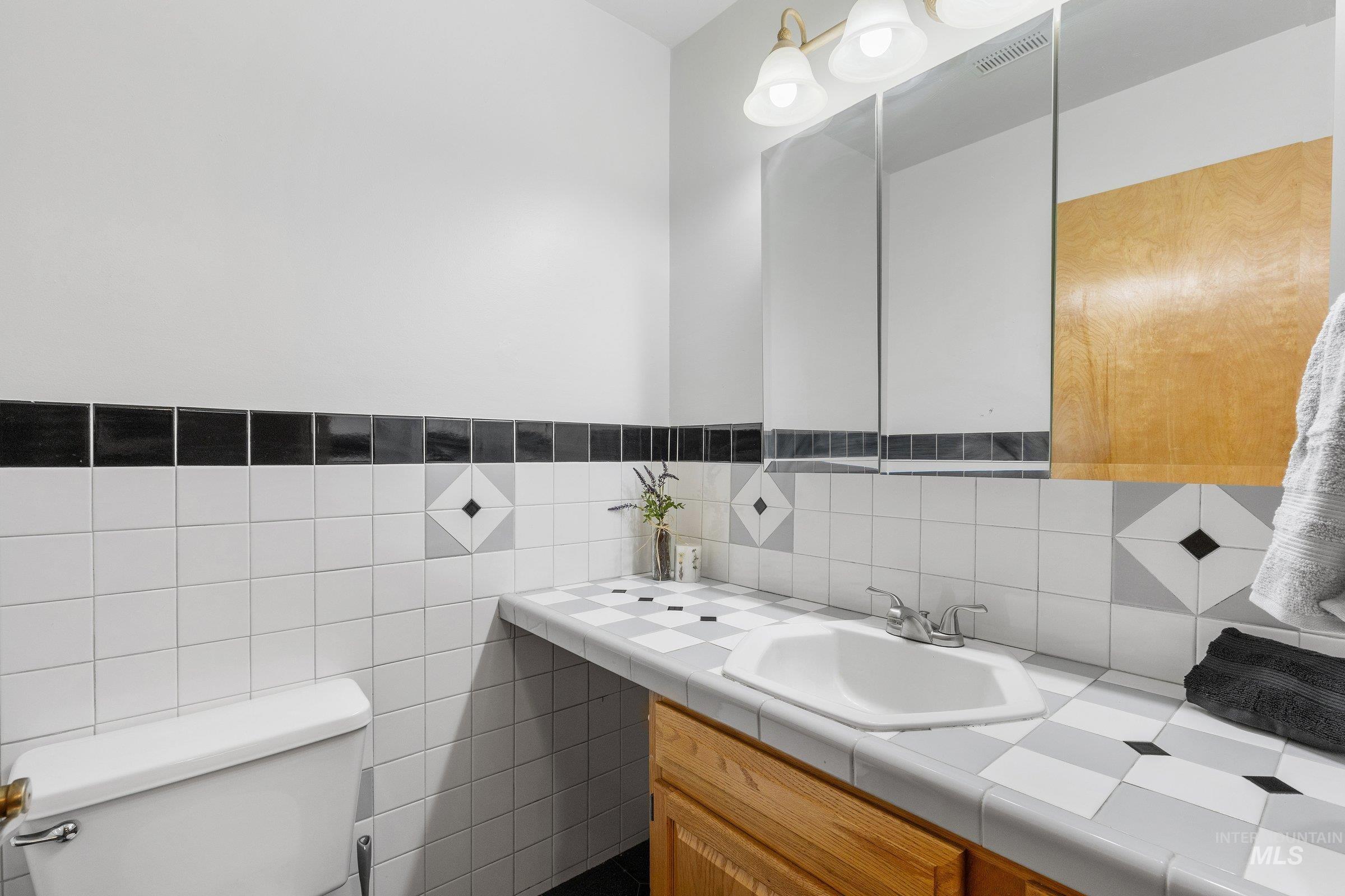 Bathroom with tile walls and vanity