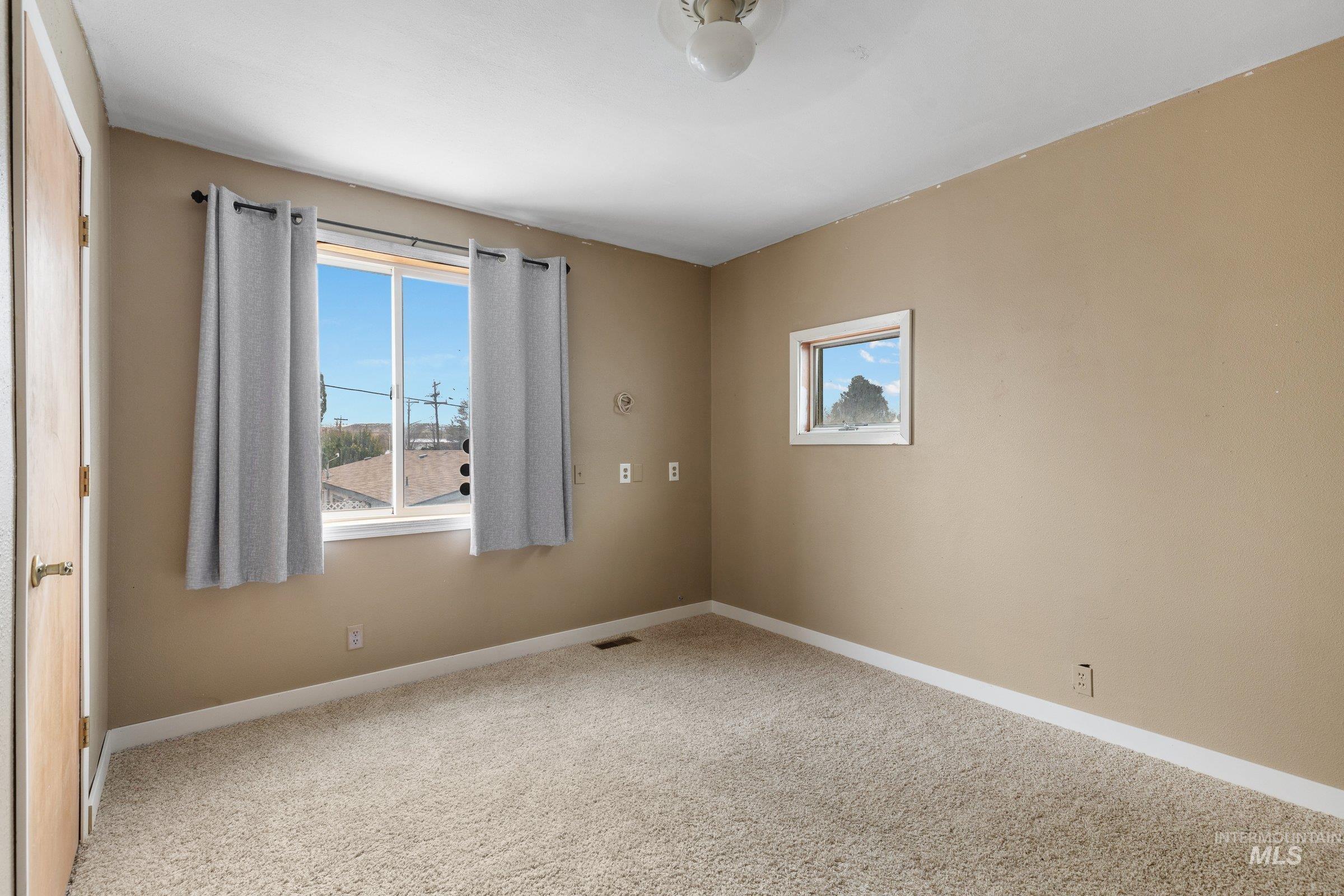 Empty room featuring healthy amount of natural light and carpet floors