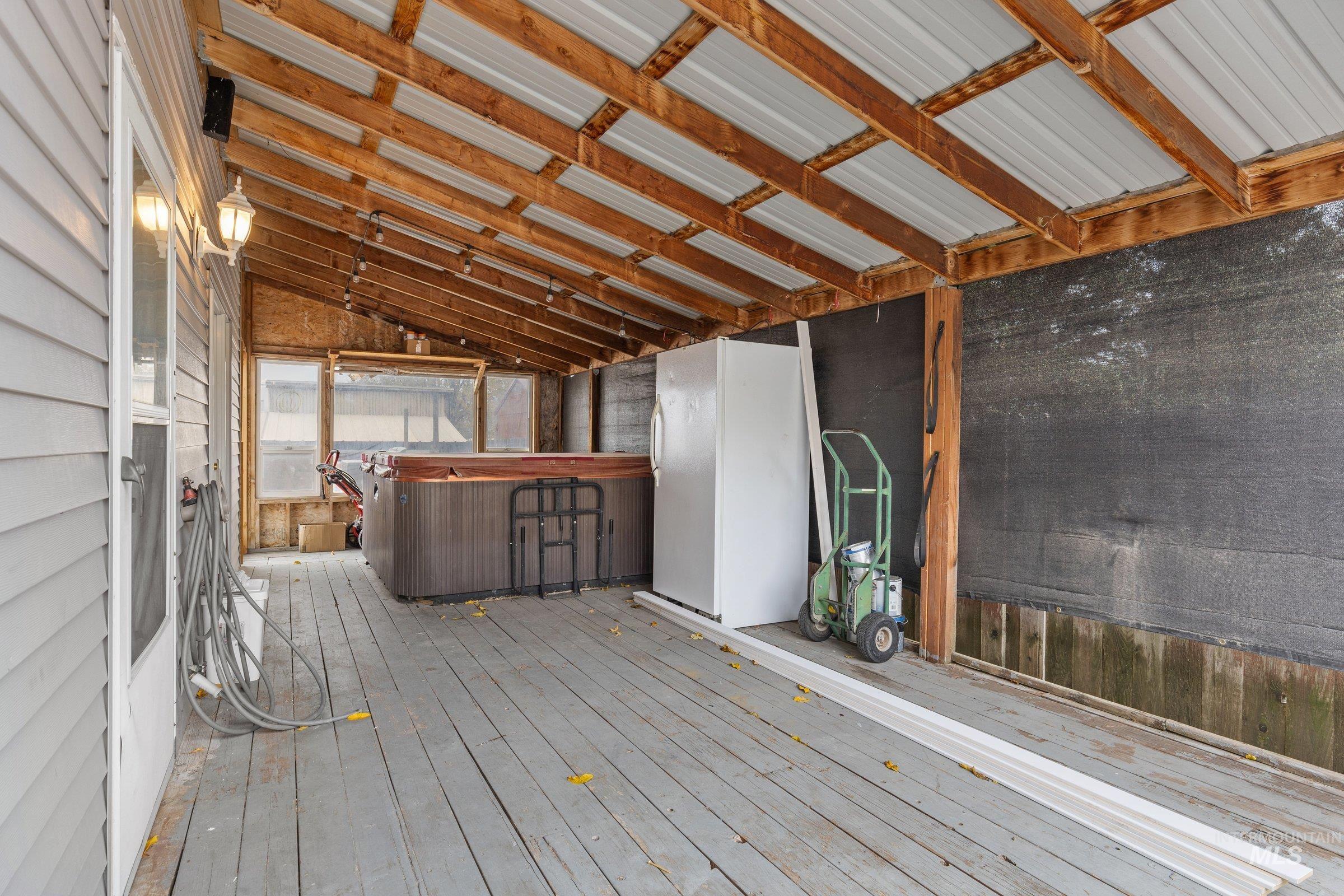 Wooden deck featuring a hot tub
