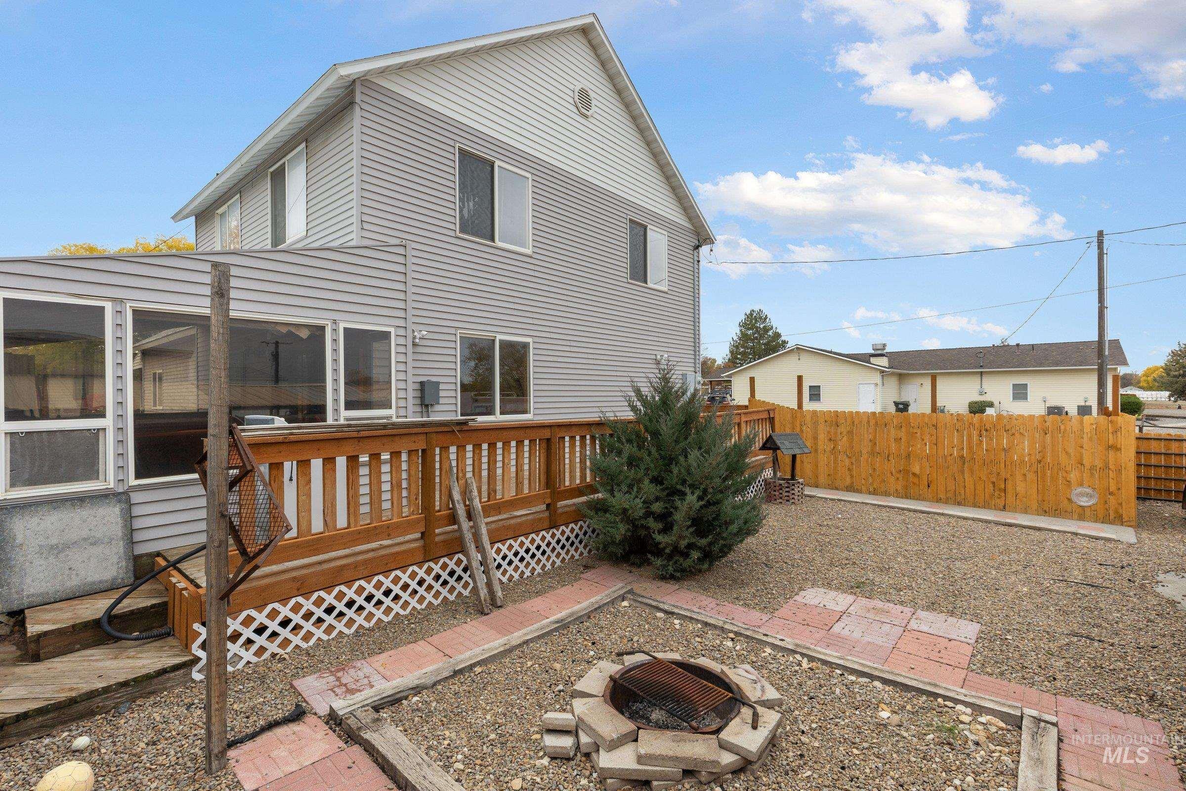 Back of house featuring a deck and a fire pit