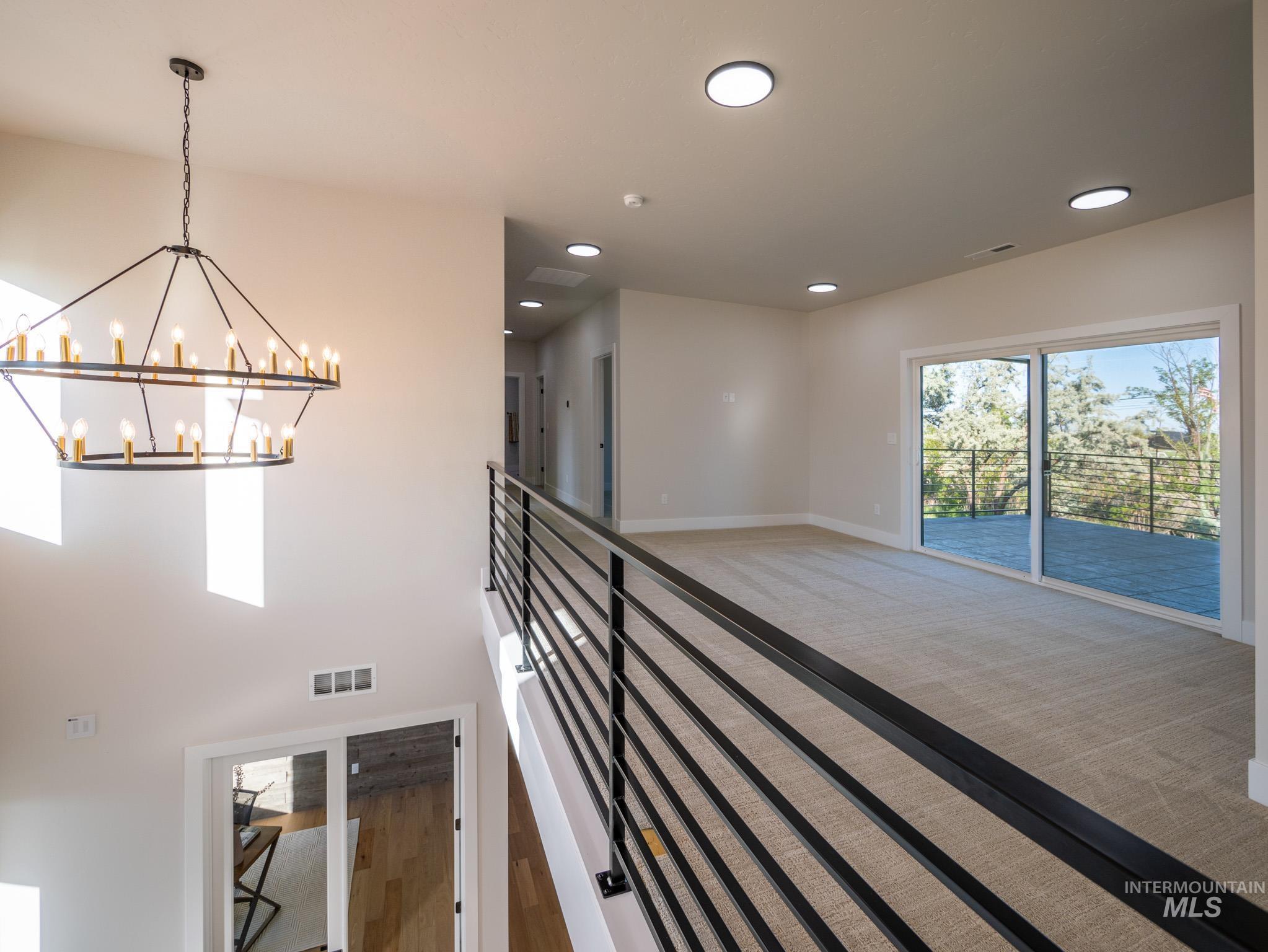 Hallway featuring a chandelier, carpet flooring, and recessed lighting