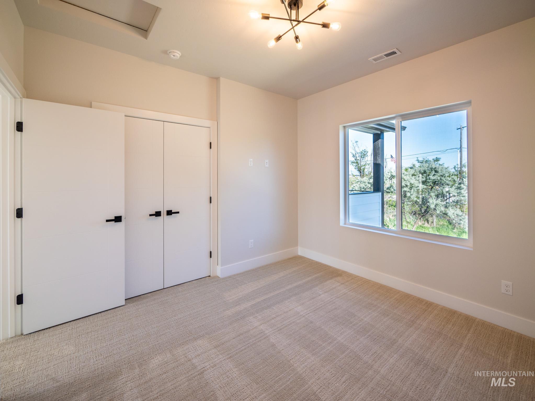 Unfurnished bedroom featuring carpet and a closet