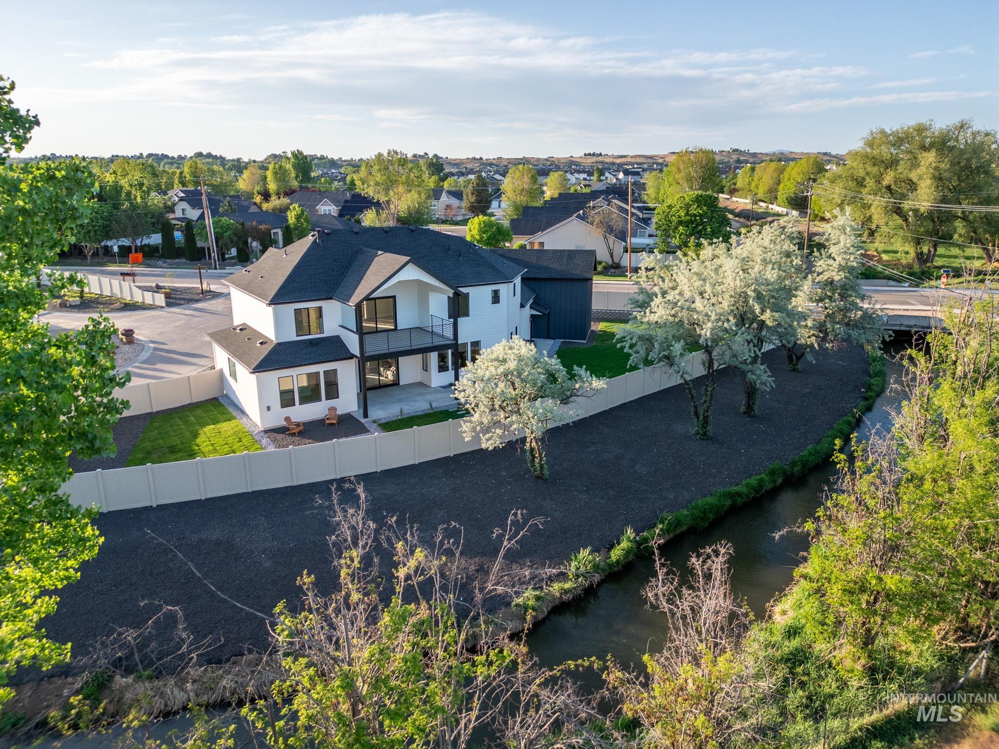 Drone / aerial view of a large body of water and a tree filled landscape