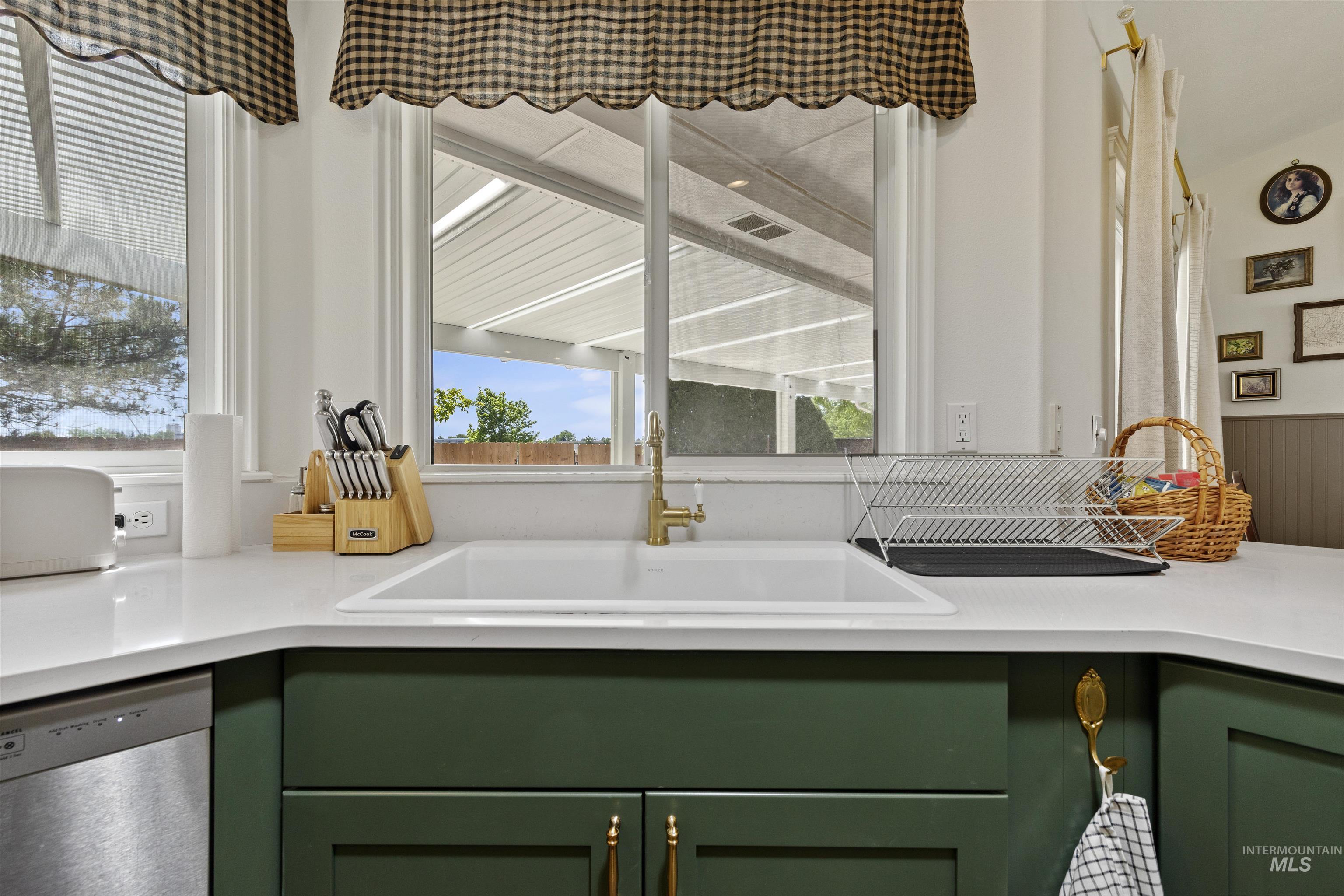 Kitchen with green cabinets and dishwasher