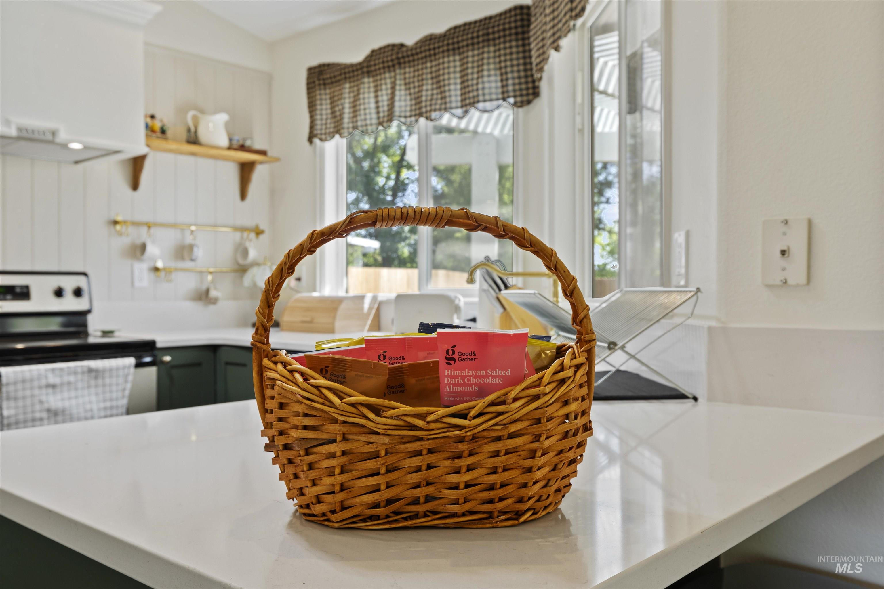 Kitchen view of open shelves and stainless steel electric range