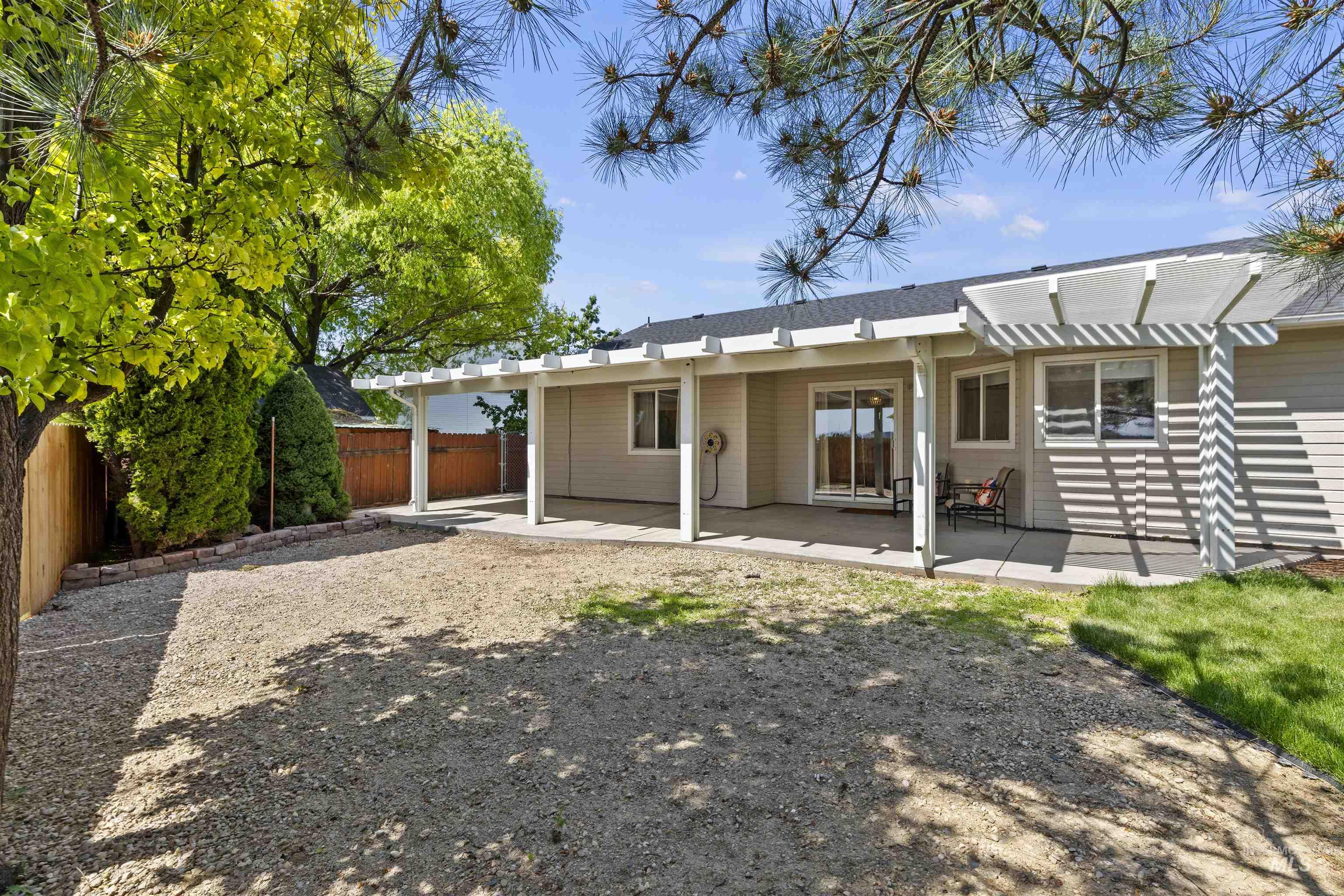 Rear view of house featuring a pergola and a patio area