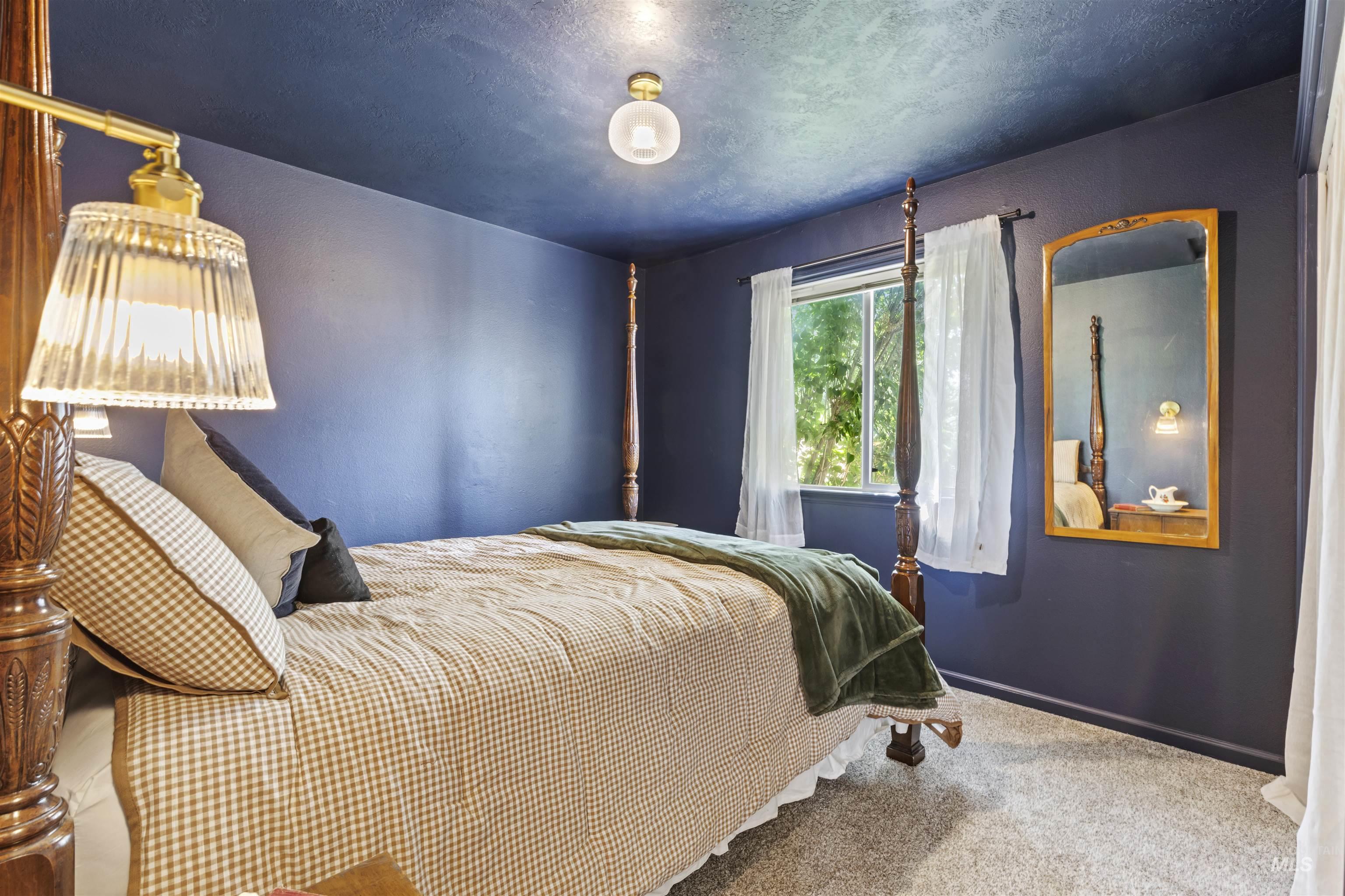 Bedroom with carpet floors and a textured ceiling