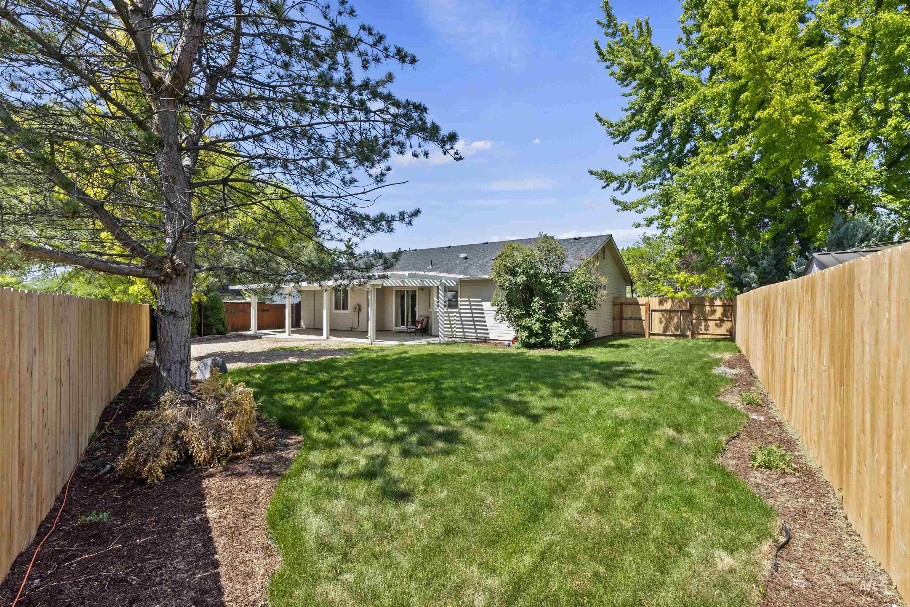 Back of property featuring a patio and a fenced backyard