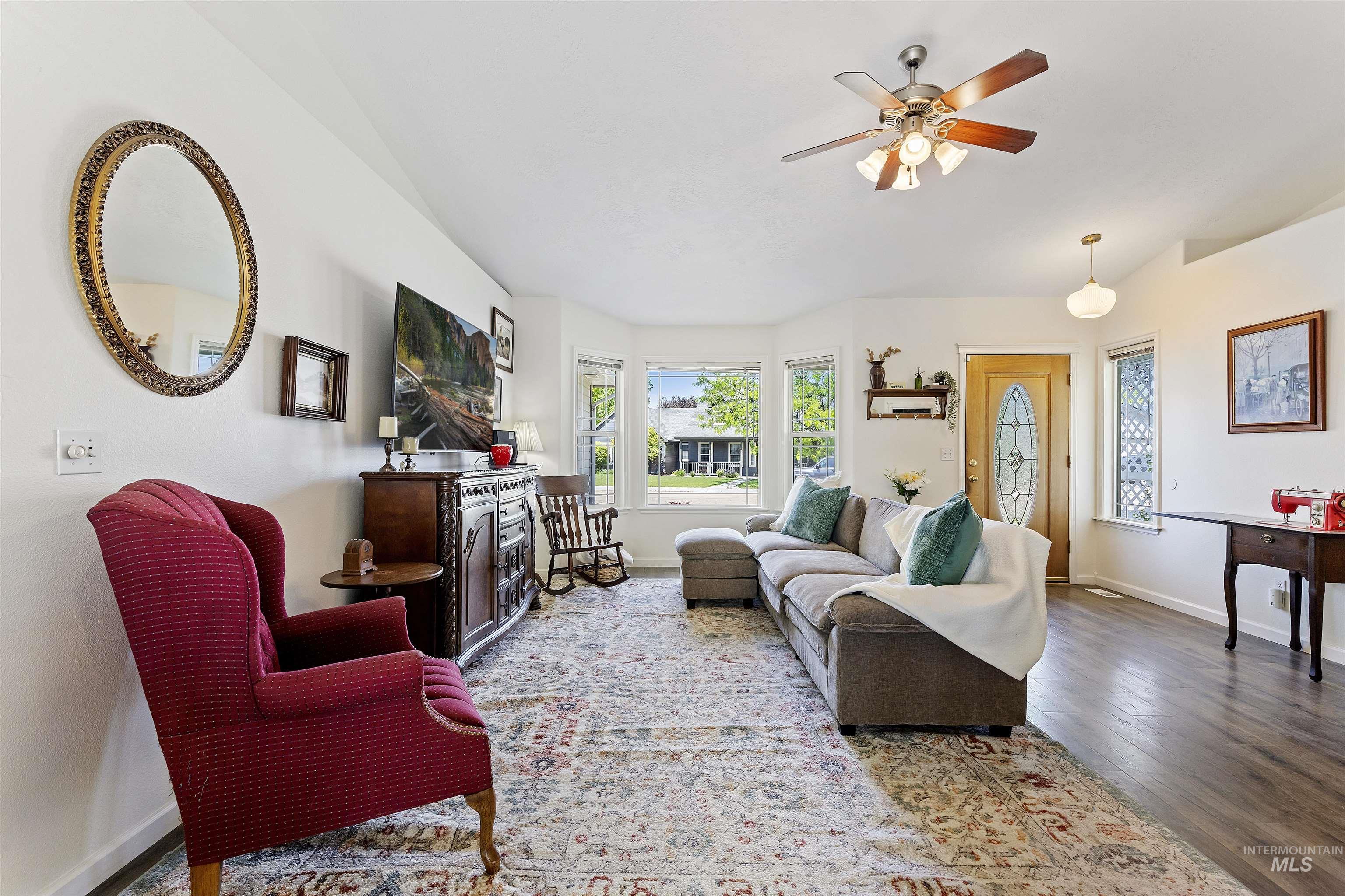 Living room featuring wood finished floors and a ceiling fan