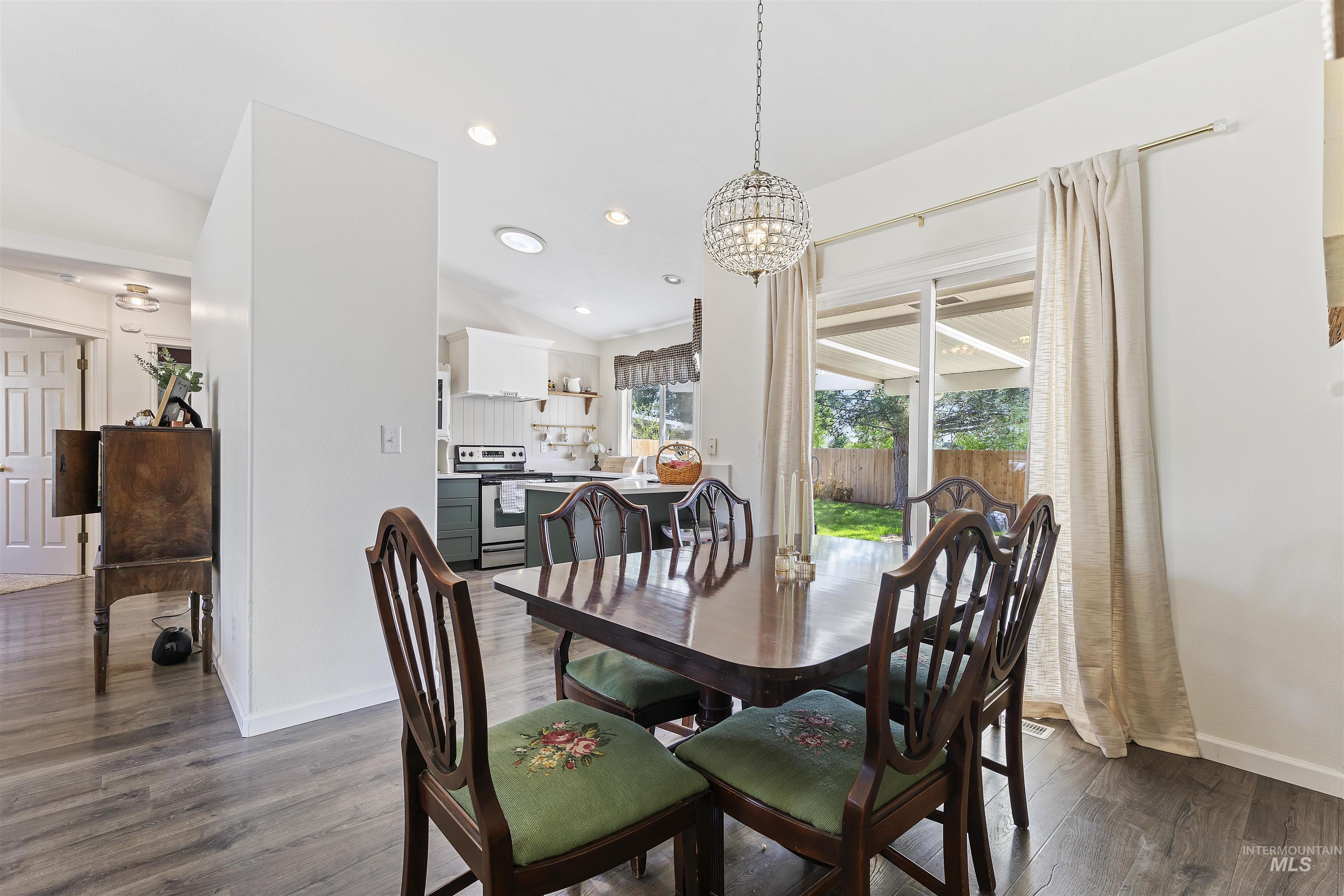 Dining space with recessed lighting, dark wood finished floors, and a chandelier