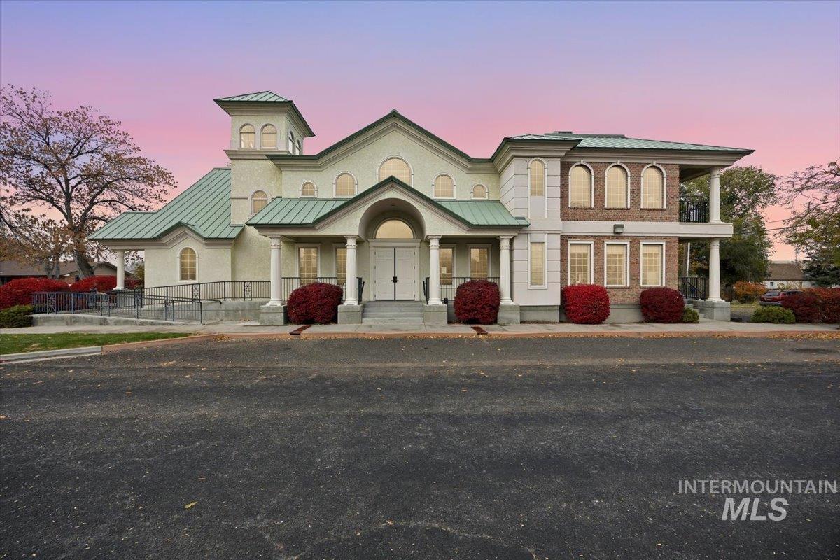 View of front of property featuring a standing seam roof, covered porch, and a metal roof