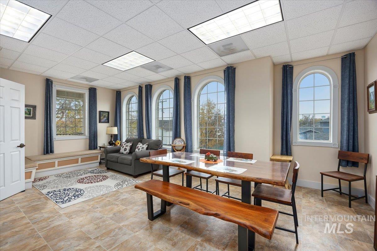 Dining area featuring a paneled ceiling and baseboards