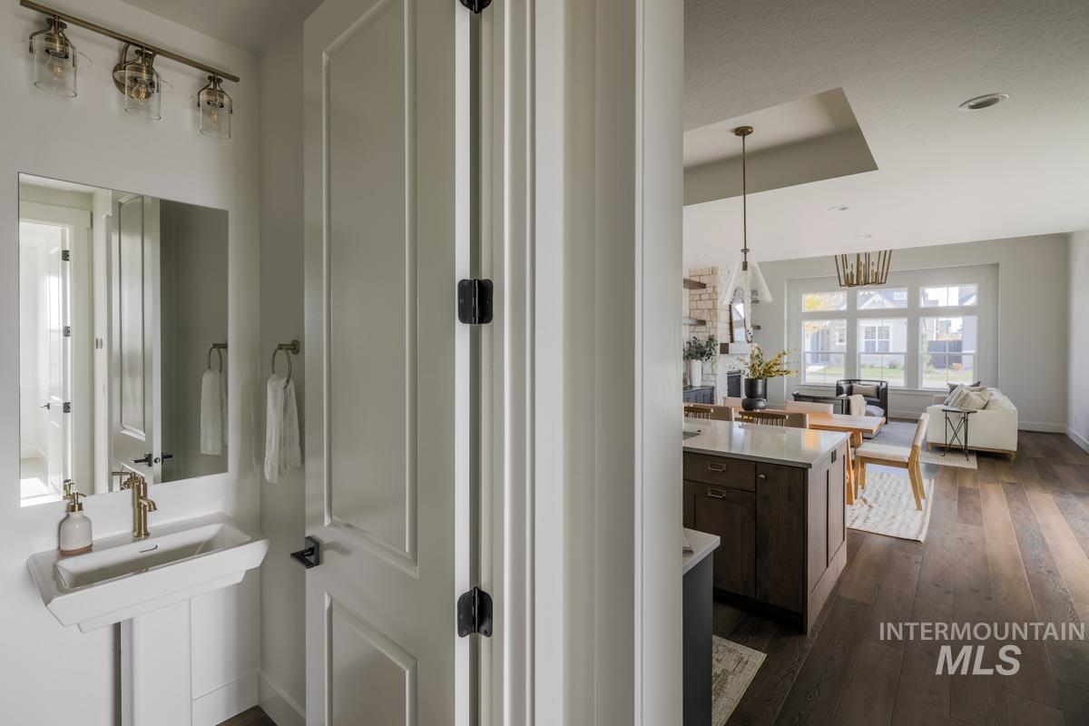 Bathroom featuring dark wood finished floors and baseboards