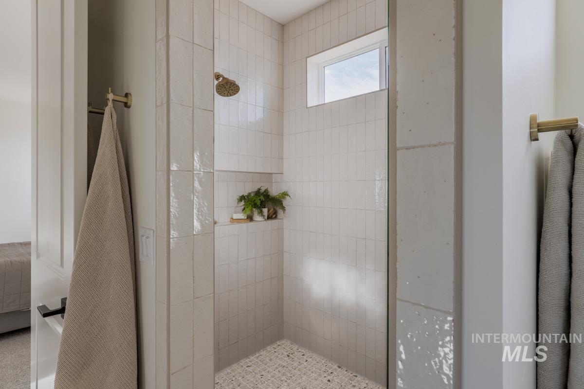 Ensuite bathroom featuring a walk in shower
