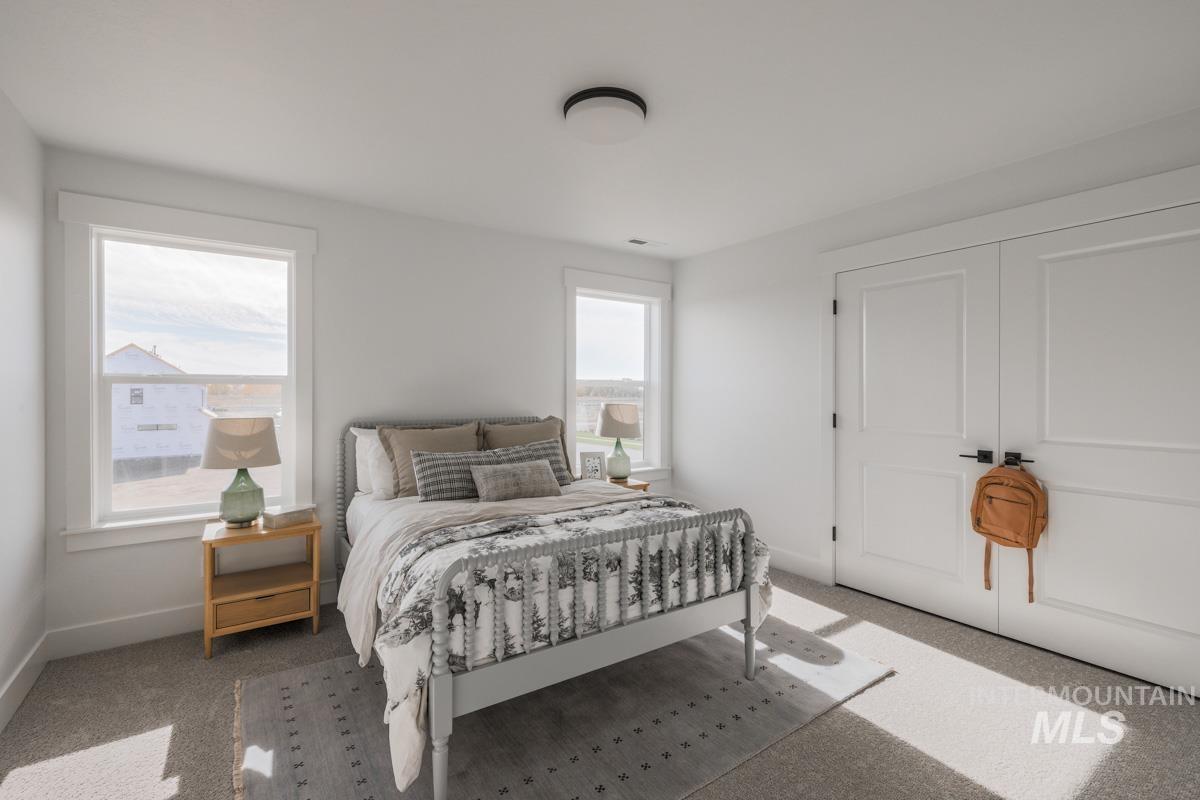 Carpeted bedroom featuring baseboards
