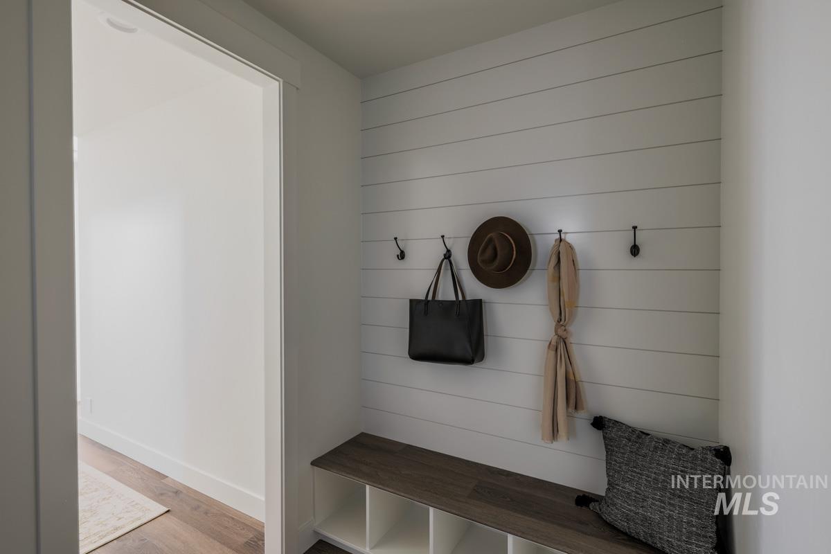 Mudroom featuring light wood-style flooring and baseboards