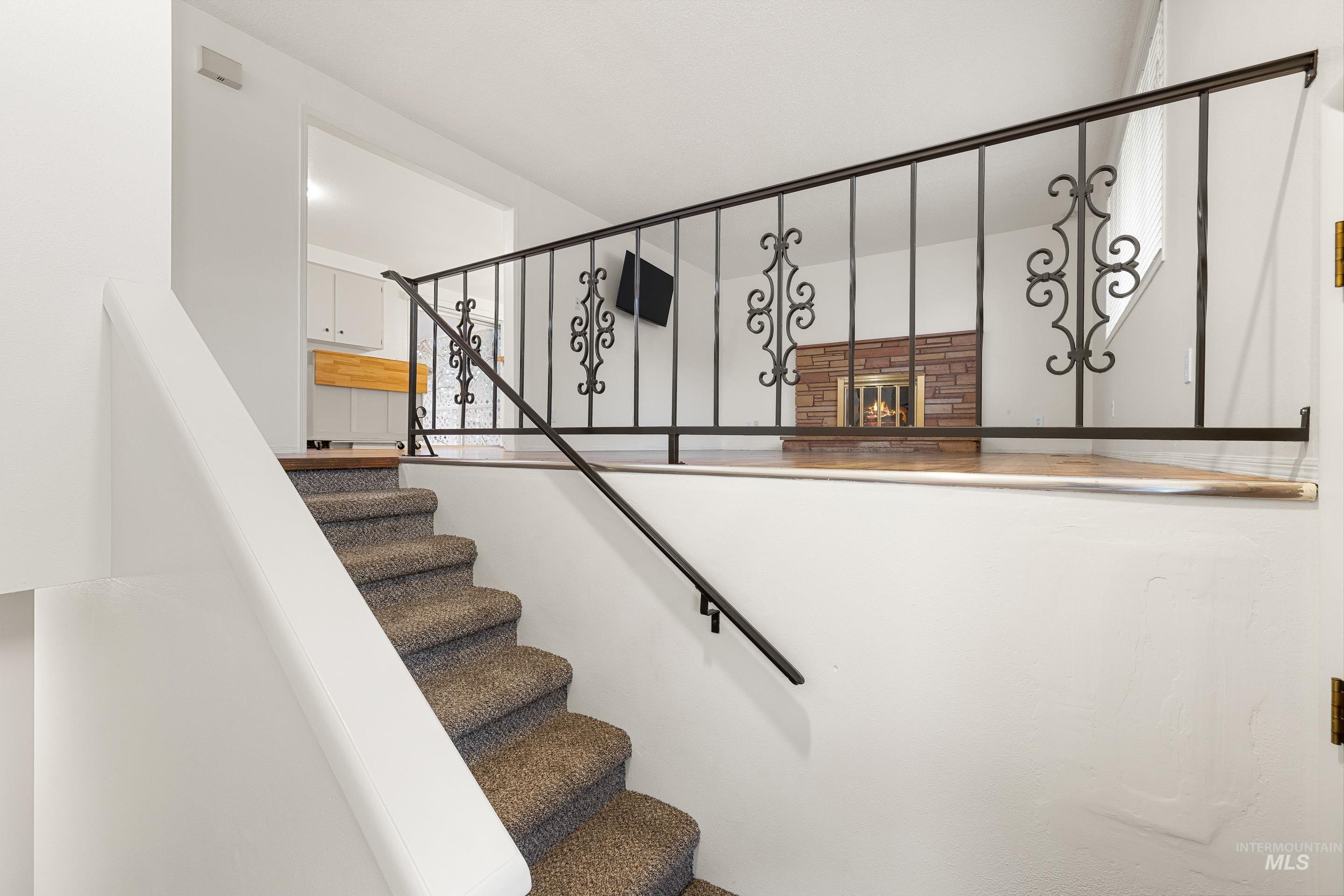 Stairs with a glass covered fireplace