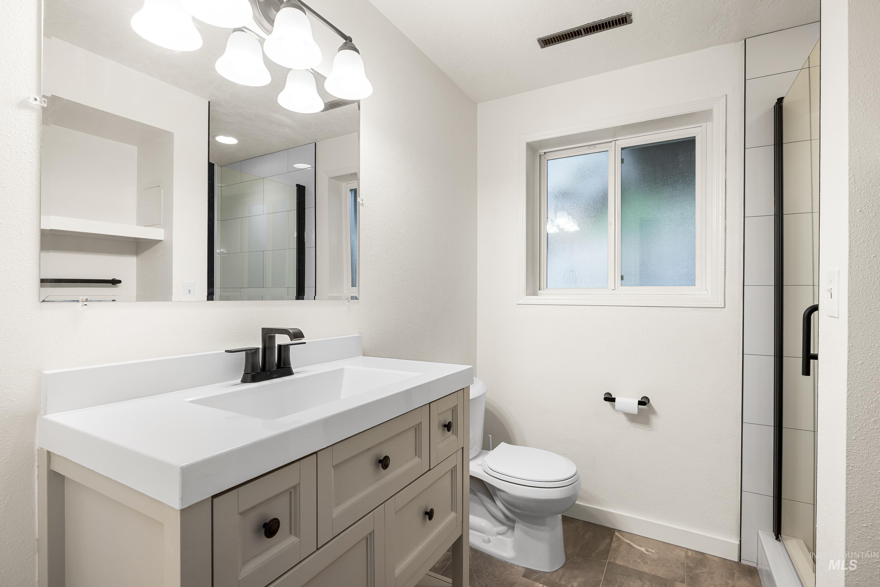 Full bath with vanity and a shower stall