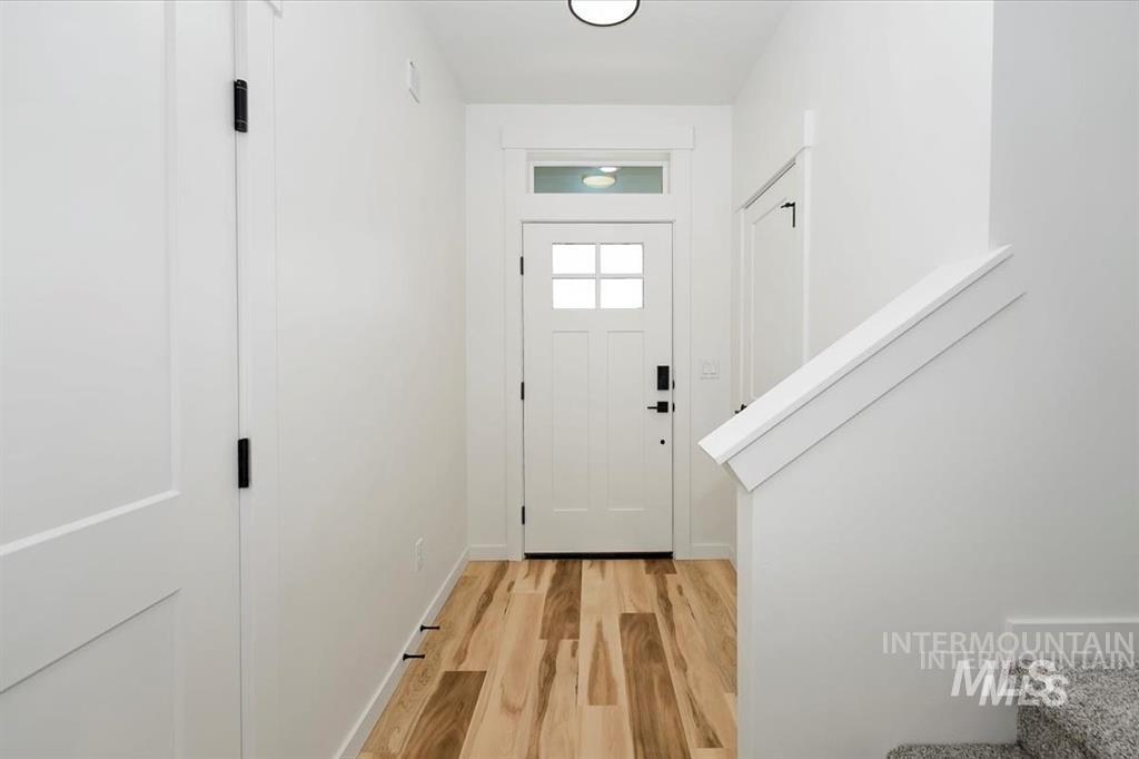 Entryway with wood finished floors and baseboards