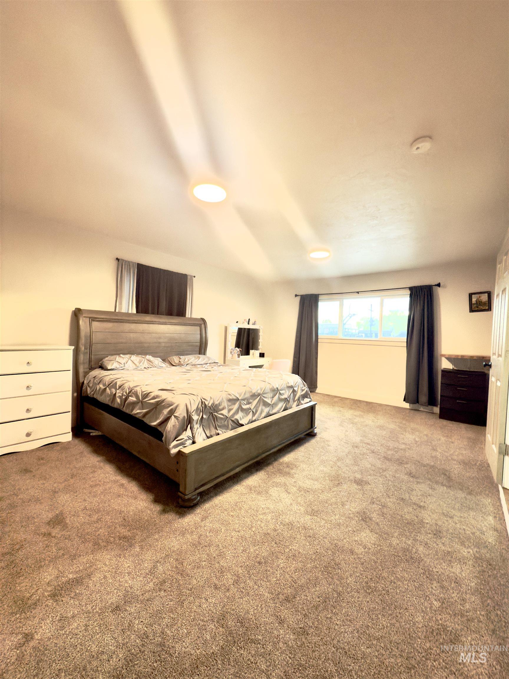 Carpeted bedroom with recessed lighting