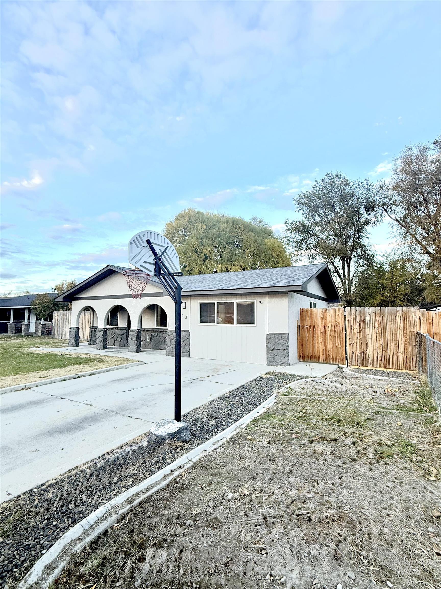 View of property exterior with stone siding and driveway