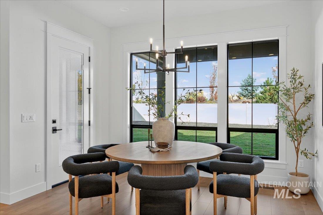 Dining area featuring light wood-type flooring and a chandelier
