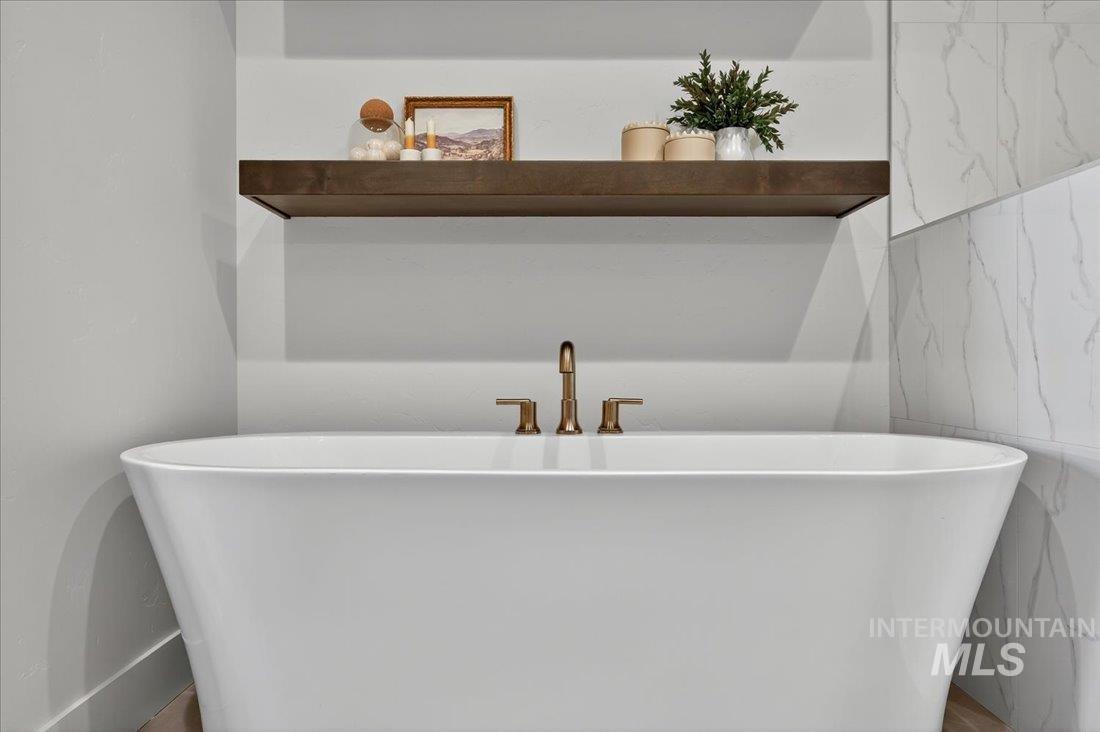 Full bath with a freestanding bath and tile walls