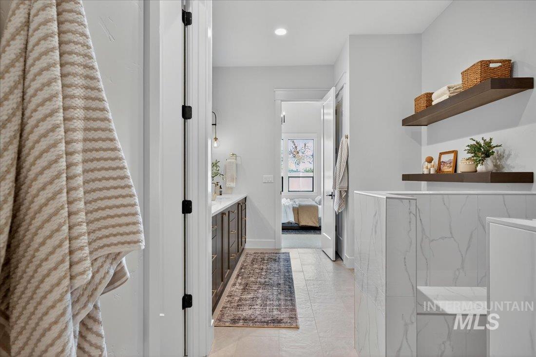Ensuite bathroom featuring vanity and recessed lighting