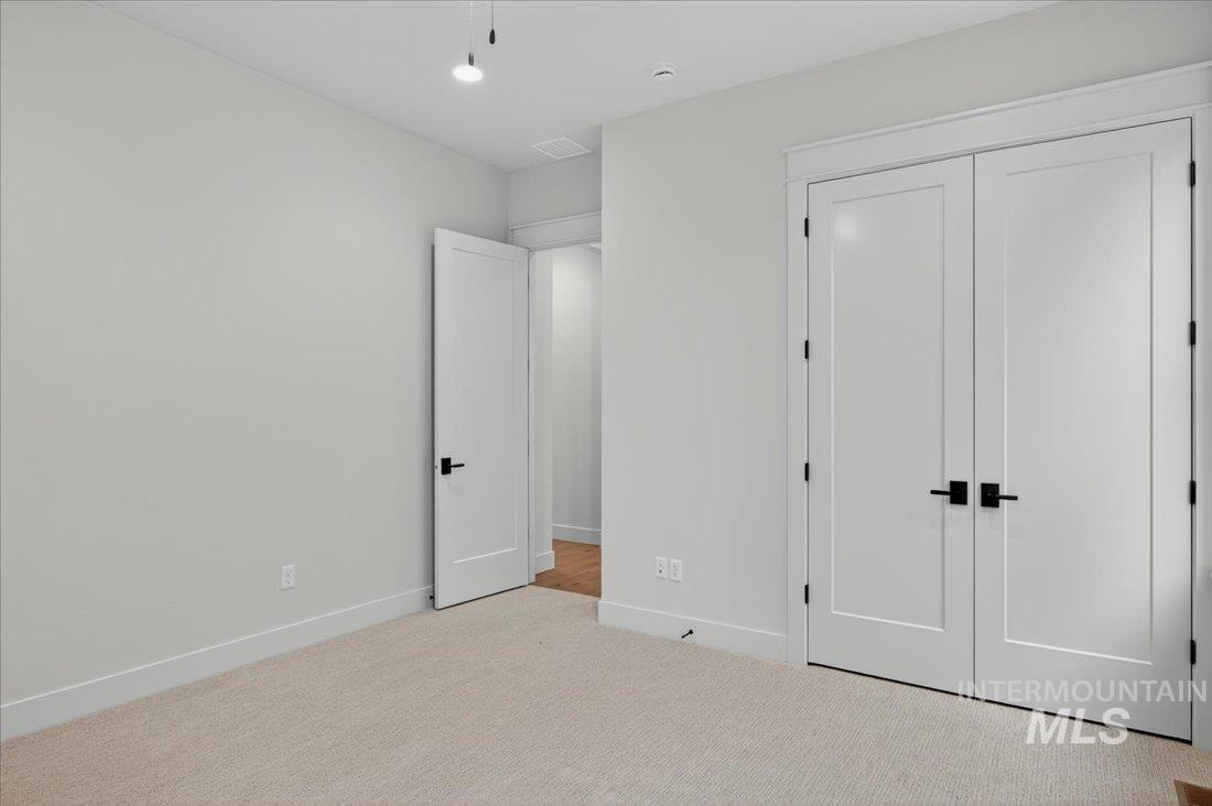 Unfurnished bedroom featuring carpet floors and a closet