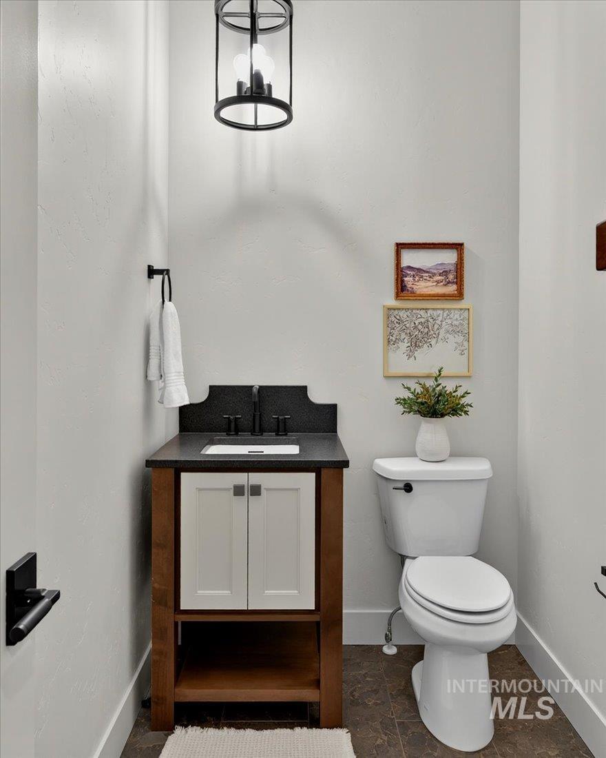 Half bath with vanity and a chandelier