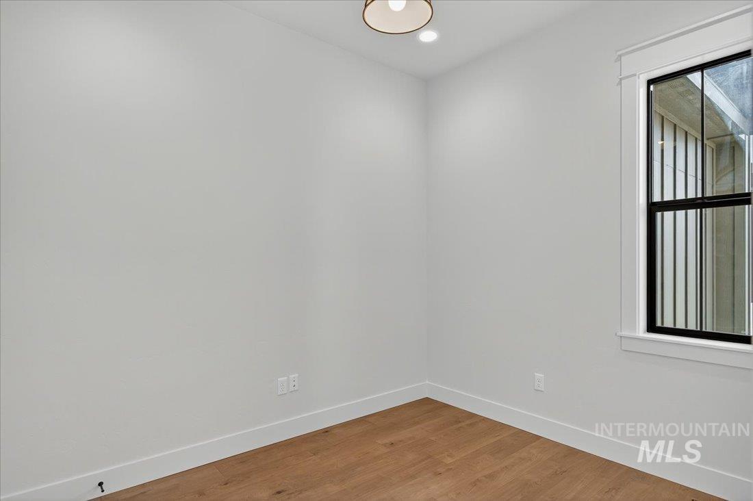 Unfurnished room with light wood-style flooring and recessed lighting