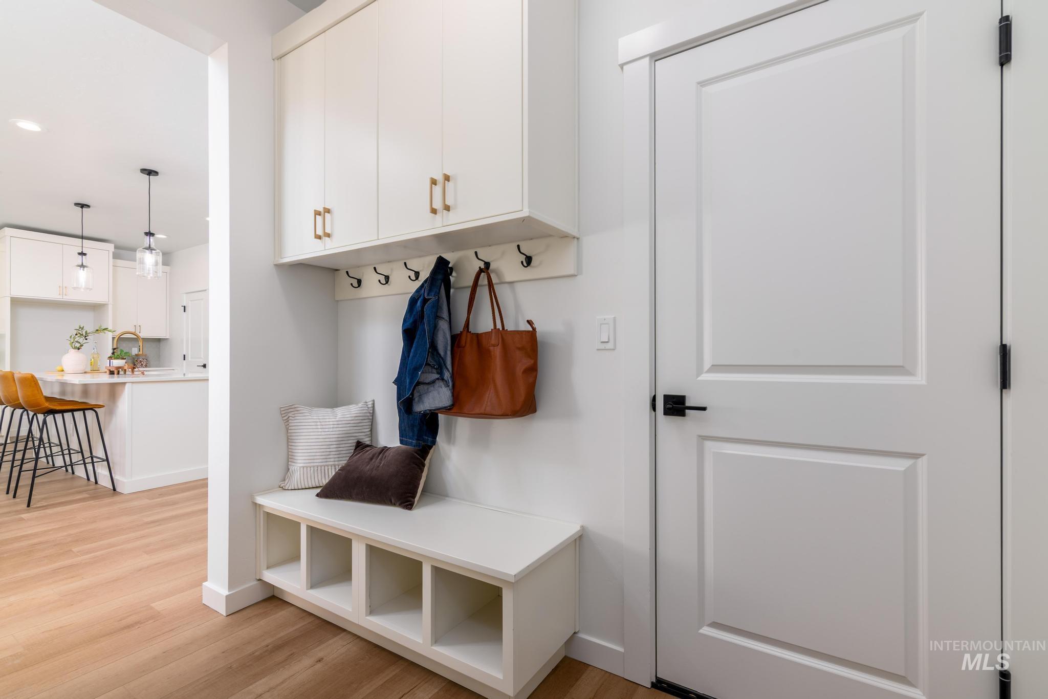 Mudroom with light wood finished floors and recessed lighting
