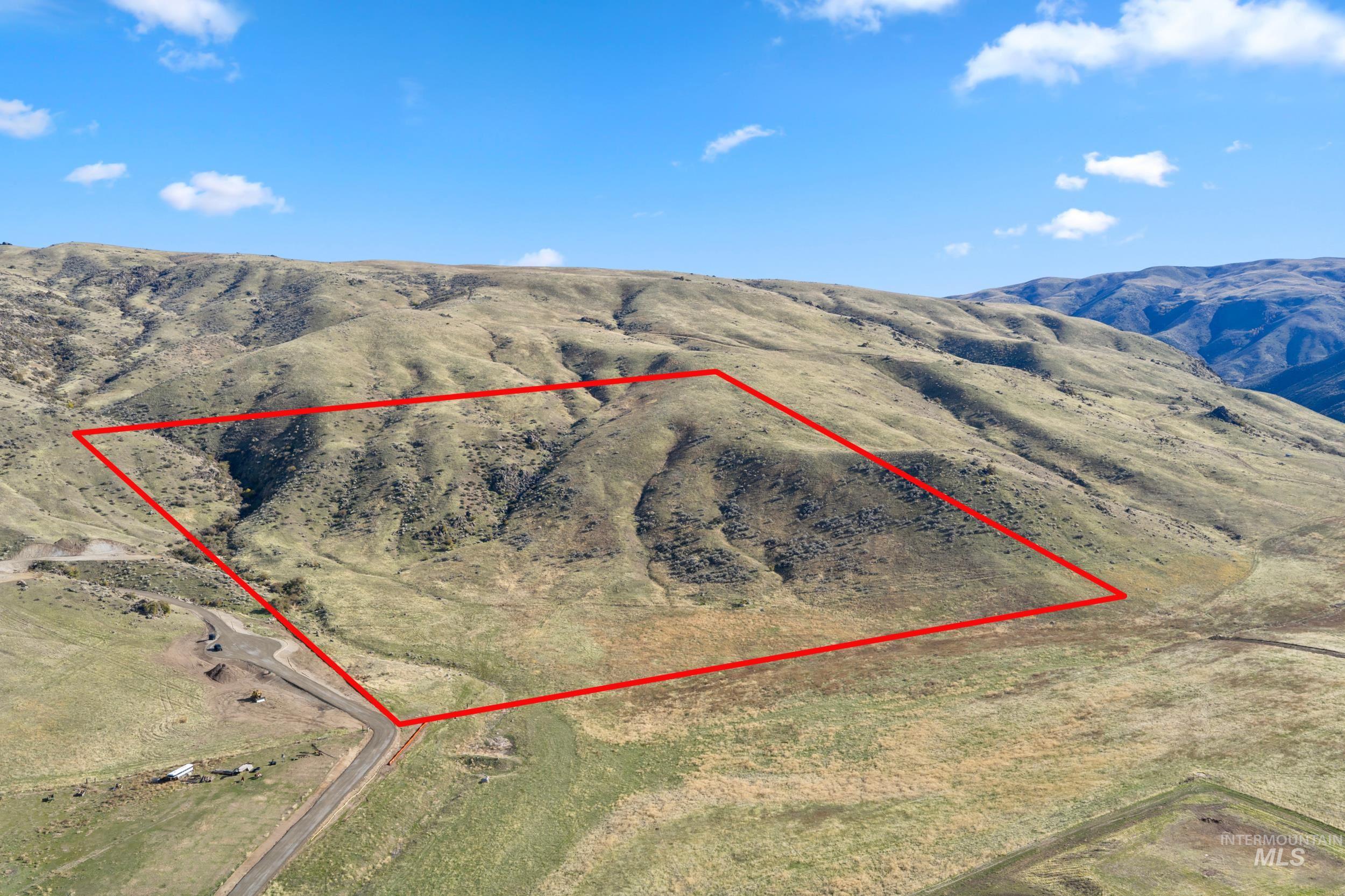 Aerial overview of property's location featuring property parcel outlined and mountains